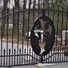 Picture of  completed driveway gate with custom  cross medallion incorporated into gate.   (Pictures of our completed  iron work projects often taken  at jobsites where other construction/ debris is still ongoing ). 