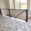 Fabricated metal rails. Homeowner to install glass panels using the metal railing as a frame for the panels.